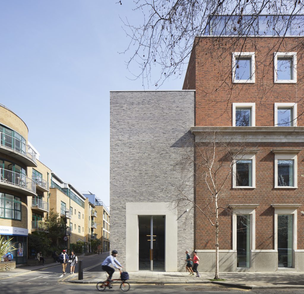 Street scene showing the corner of the Technique Building, where the lower front building meets the higher back.