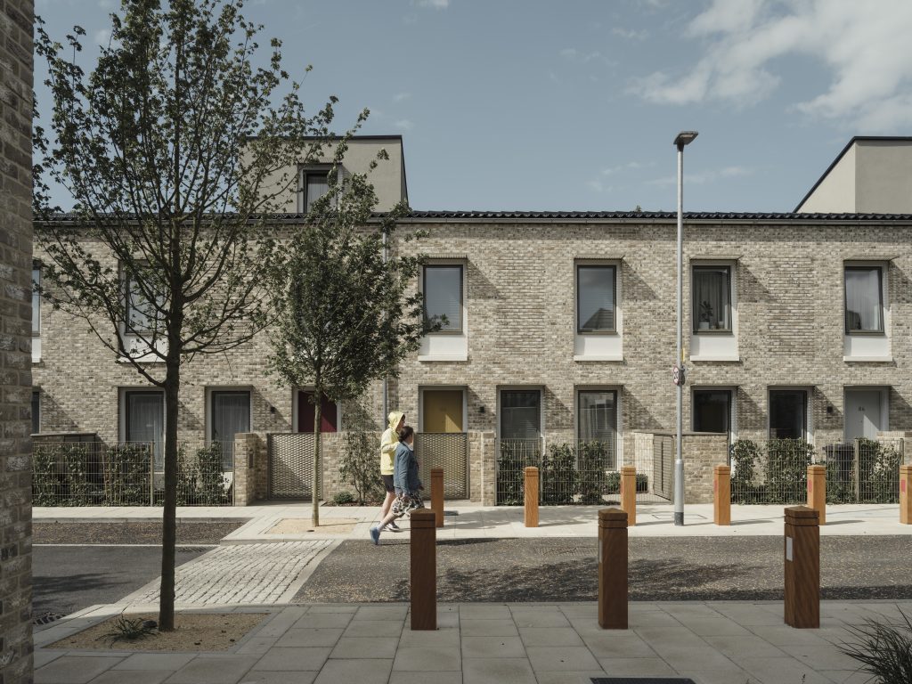 Street view of Goldsmith Street: brick-clad timber housing.