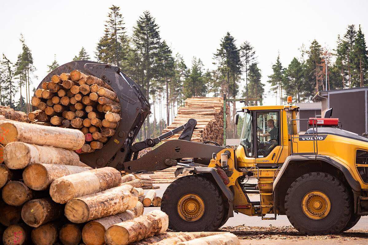 Rettenmeier. Shot of logs being handled by machine on site.